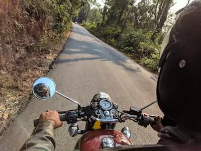 men driving motorbike wearing earplugs