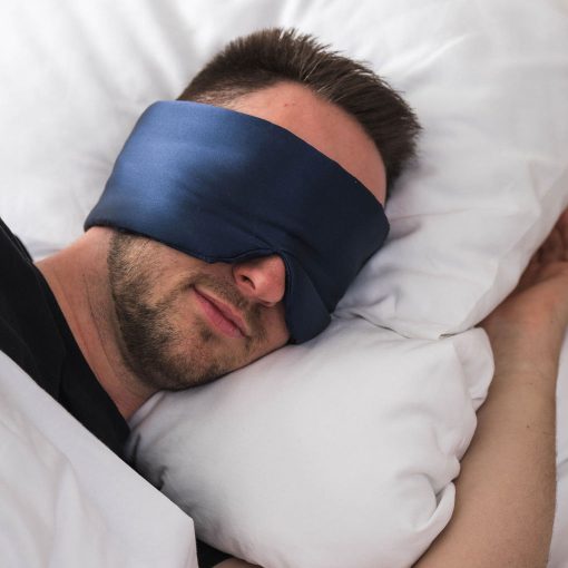 Man peacefully sleeping with deep sleep mask
