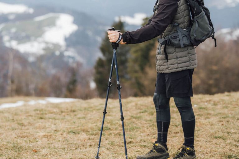 man standing with alpine research poles